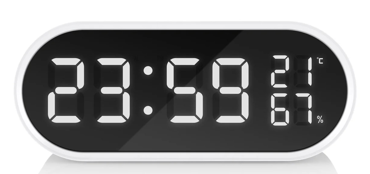 Zegar cyfrowy wyświetlający 23:59, 21 stopni Celsjusza i 67% wilgotności. Białe cyfry na czarnym tle, w białej ramce.