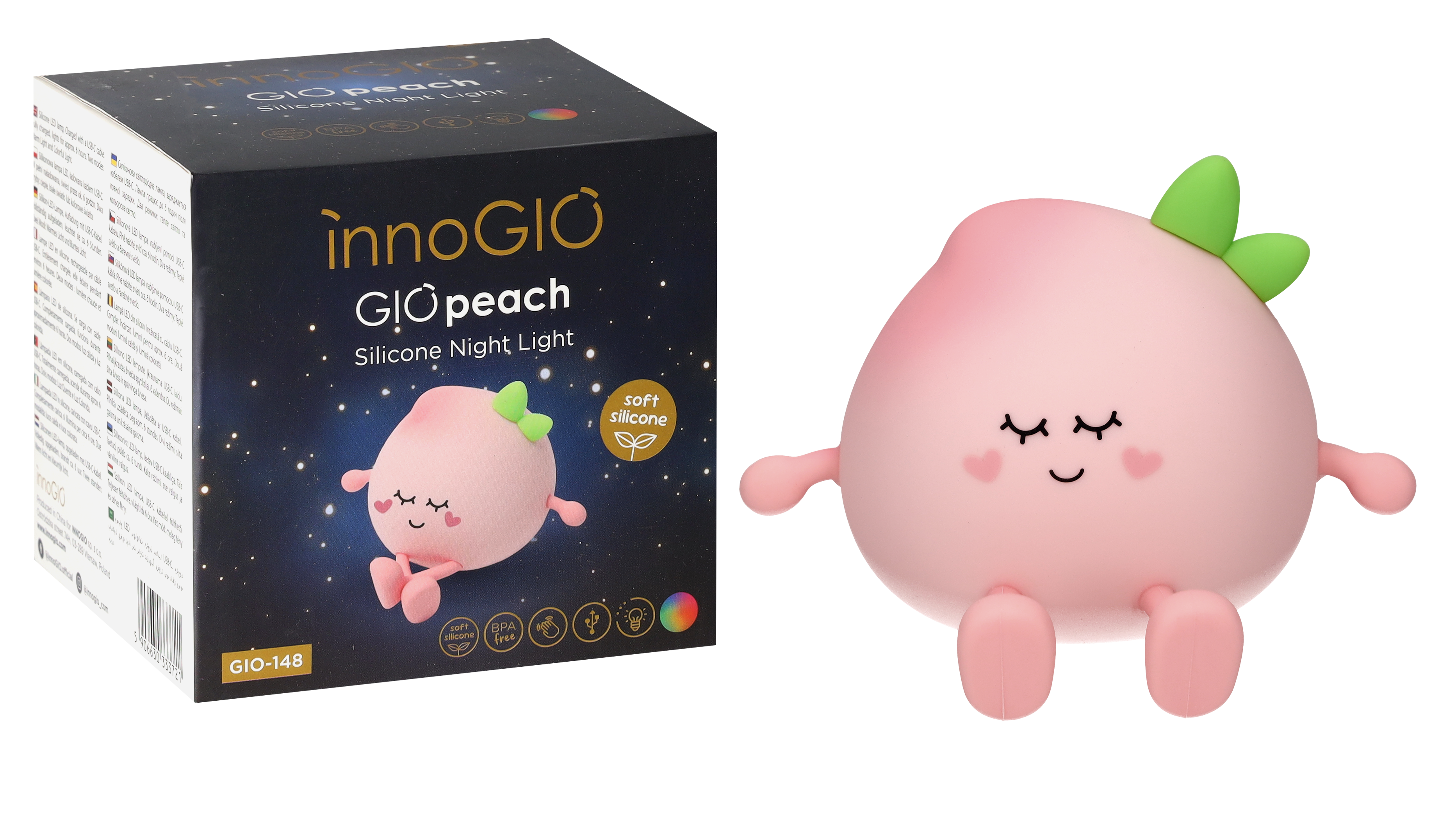 Różowa lampka nocna w kształcie brzoskwini z zamkniętymi oczami, zielonymi liśćmi i pudełkiem z tekstem i ilustracją brzoskwini.