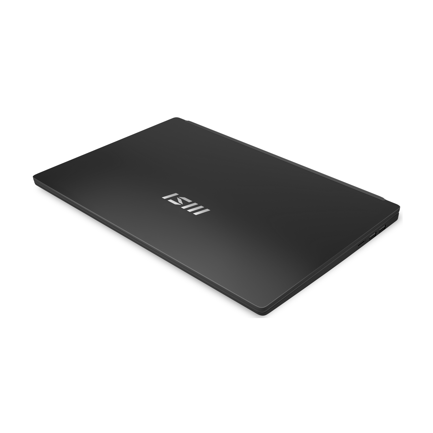 Un laptop nero su una superficie bianca. Il coperchio è chiuso, con il logo MSI visibile e leggermente angolato.