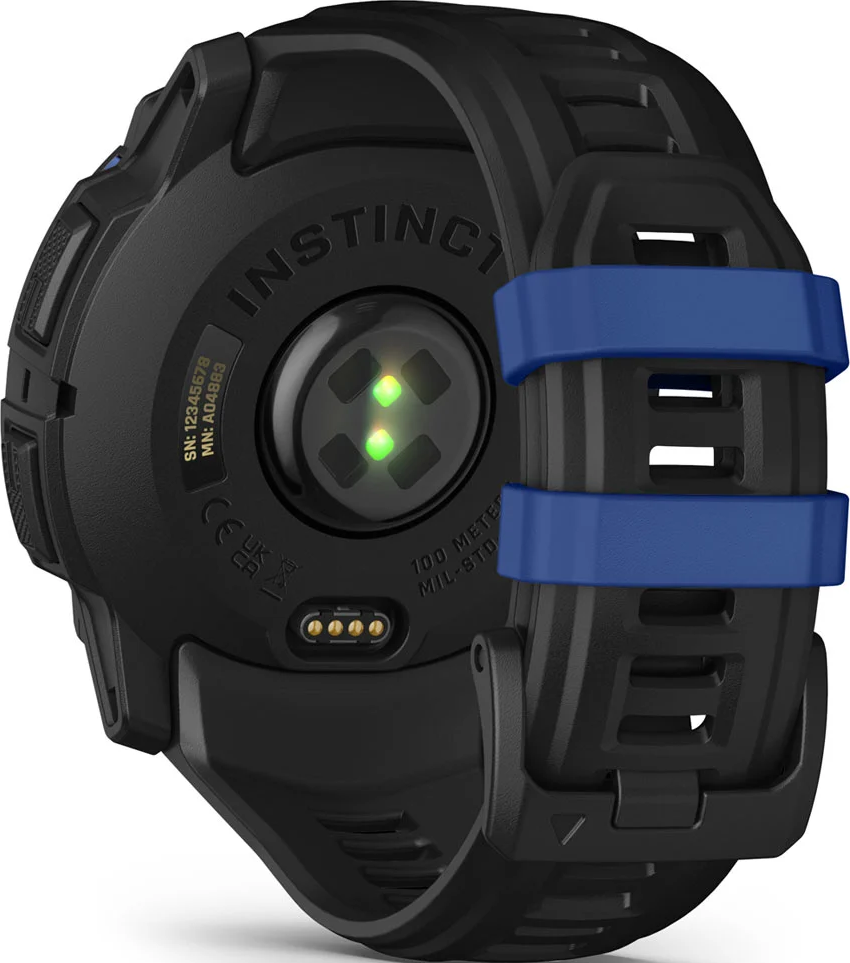 Dos de montre connectée noire avec bracelet bleu. Inclut capteur de fréquence cardiaque, port de charge et infos produit. 'INSTINCT' est visible.