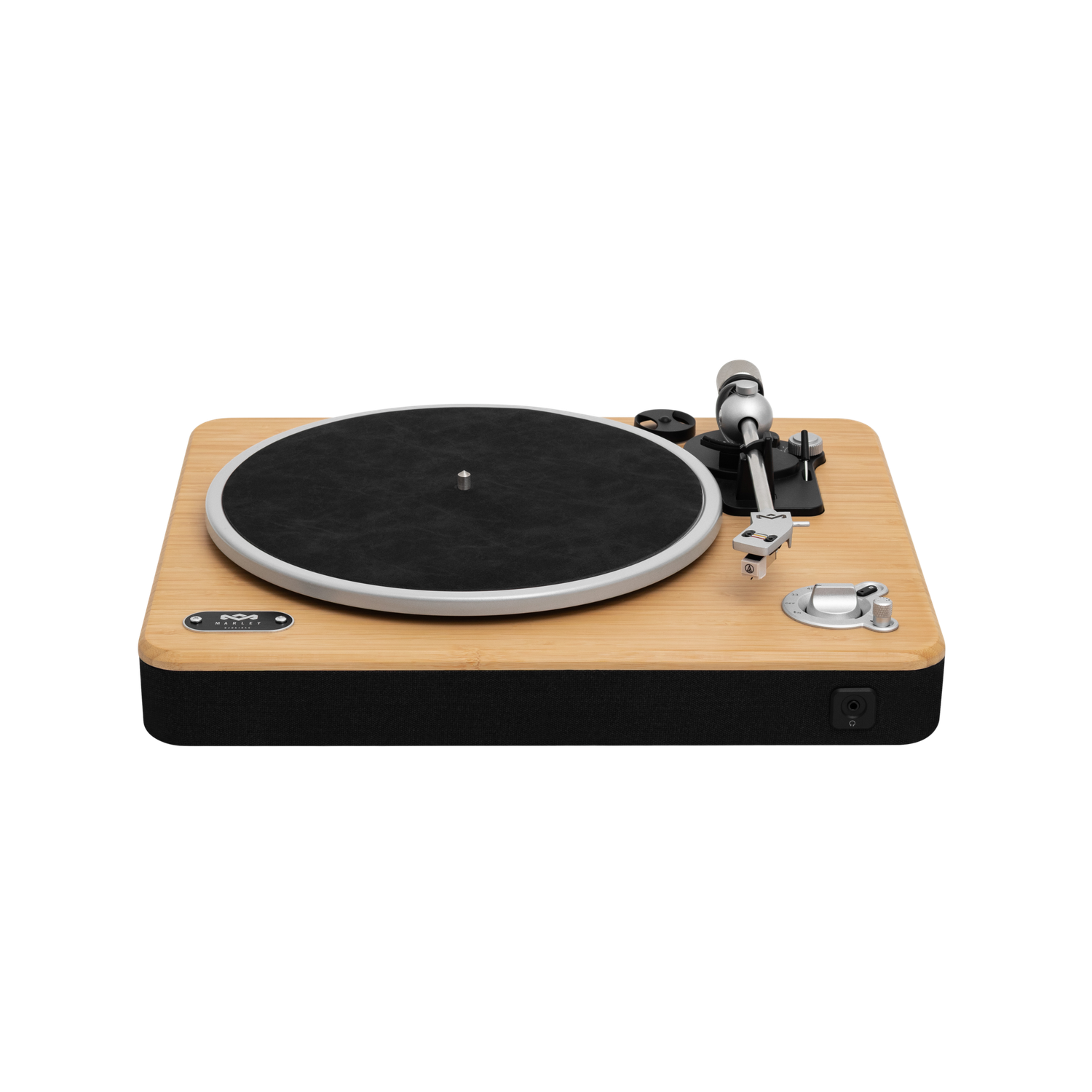 A turntable with a black record, silver arm, and wooden base. It has a black fabric border and silver controls, set against black.