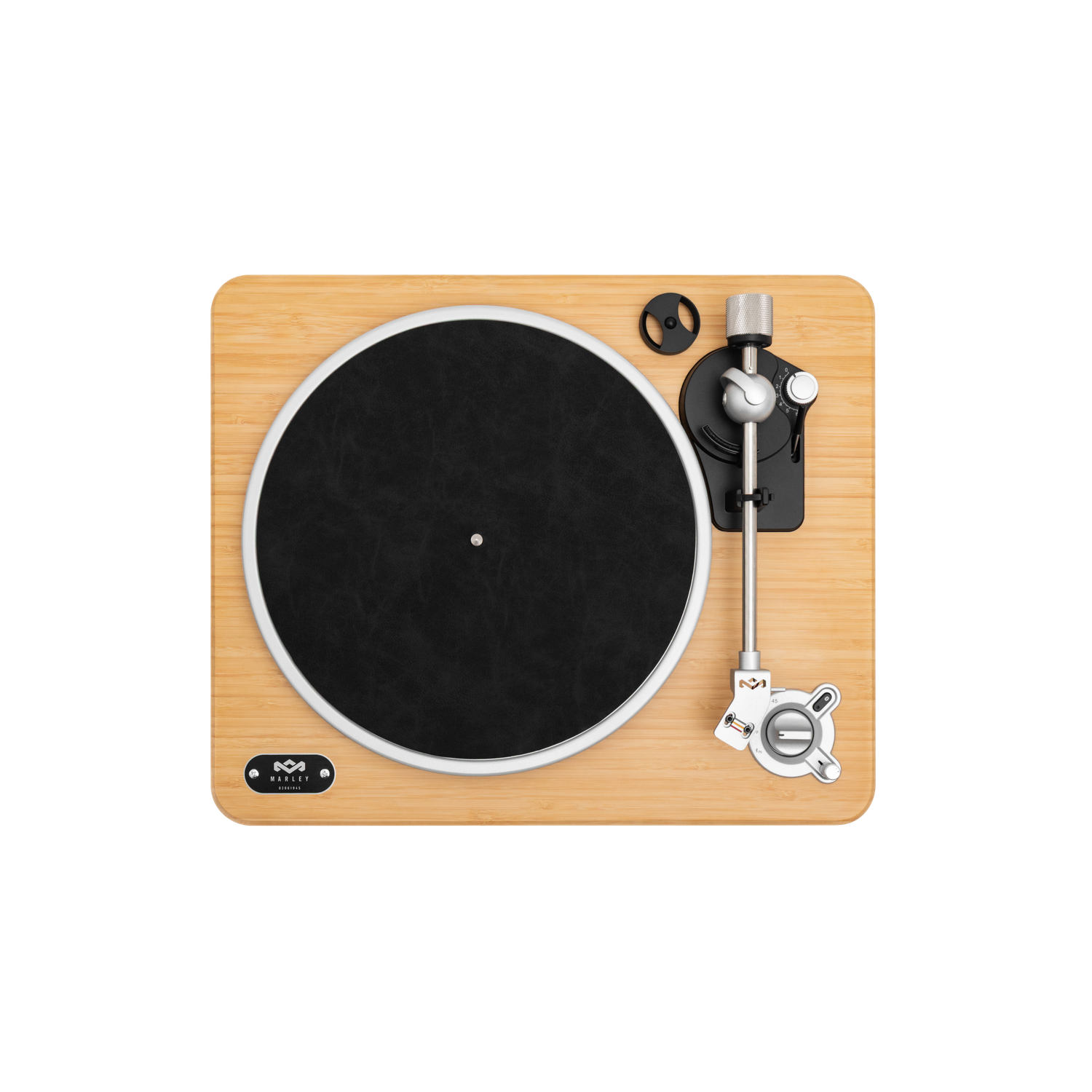 A turntable on a light wood surface. A black record is in the center. The turntable has a silver tone arm and controls.