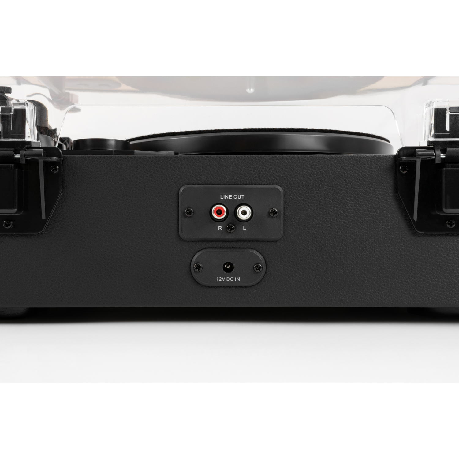 Close-up of a black record player with a clear cover. It has line out ports and a power input. The surface is textured.