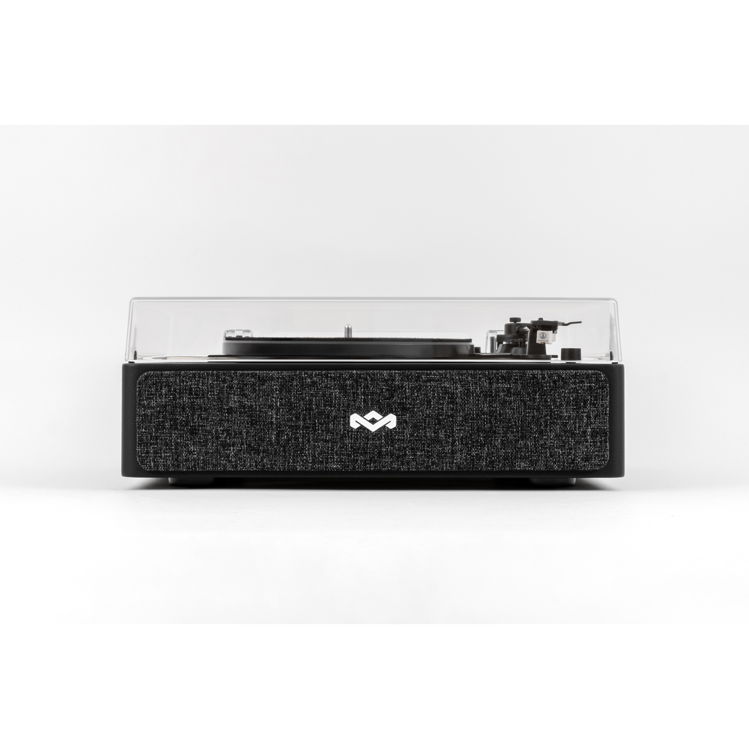 A black record player with a clear cover. It has a woven fabric front and a white logo. The turntable is on a white background.
