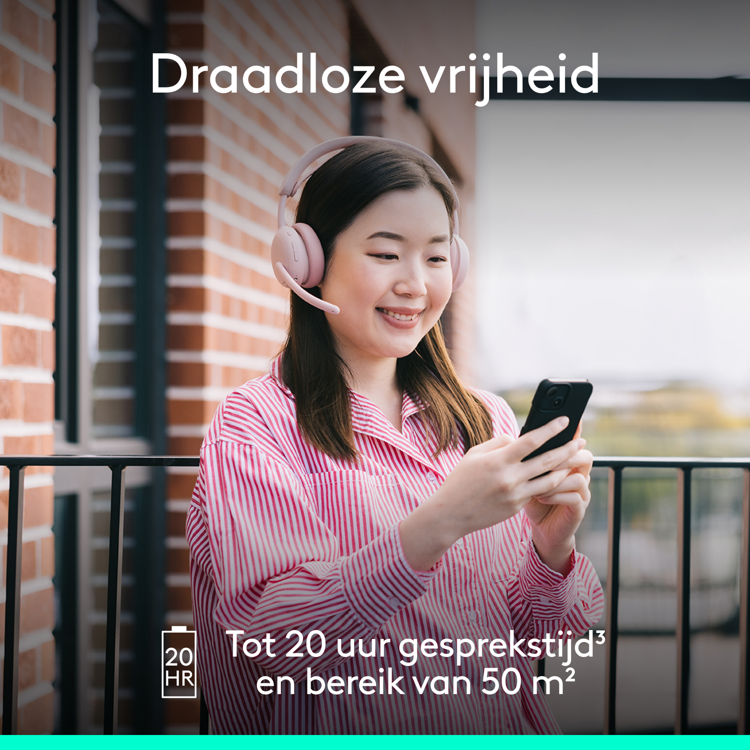 Woman on a balcony wearing pink headphones, holding a phone, smiling. Text says 'Wireless freedom' and 'Up to 20 hours talk time'.