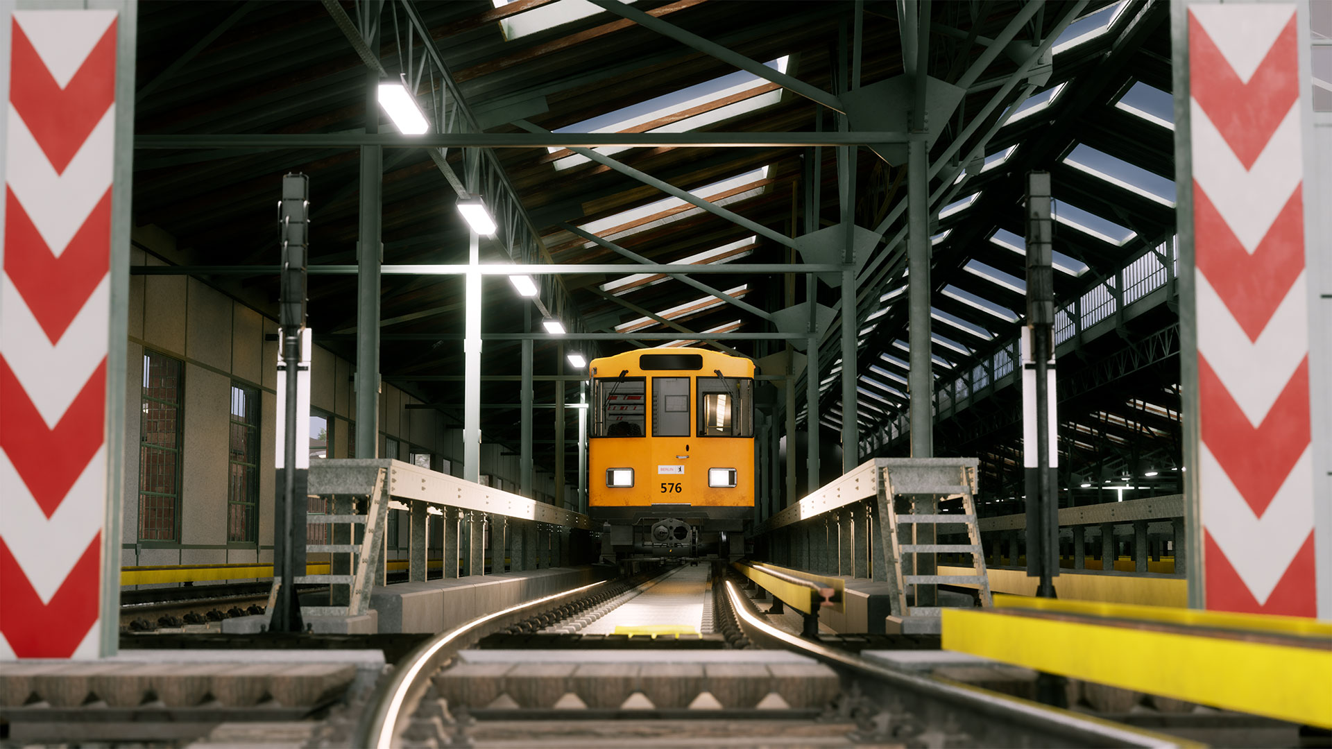 Ein orangefarbener Triebwagen steht mittig auf Gleisen in einer Station, mit rot-weißen Chevron-Markierungen an den Seiten.