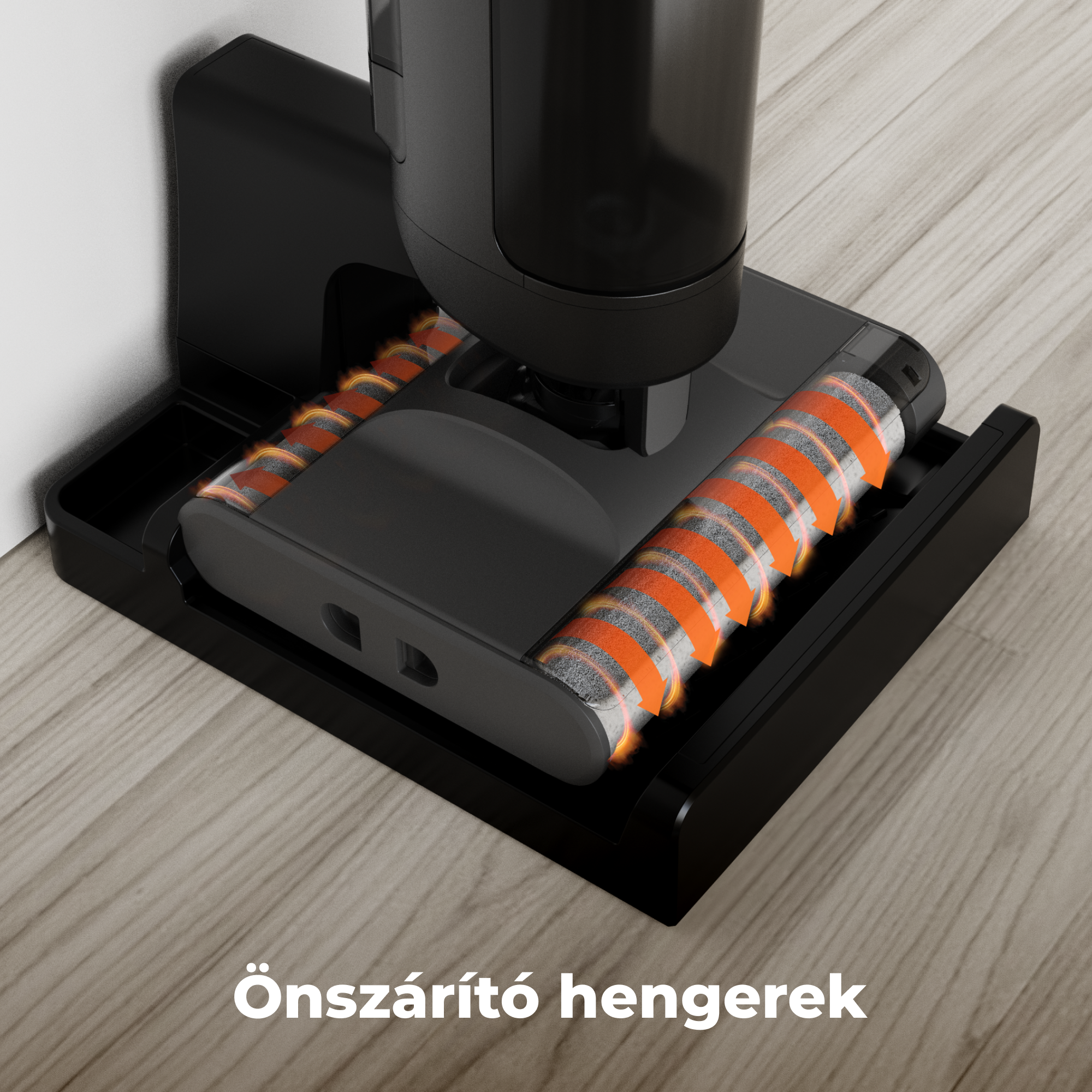 Fekete porszívóalap narancssárga és szürke görgőkkel, fa padlón. A szöveg a következőt mondja: 'Önszárító hengerek'.