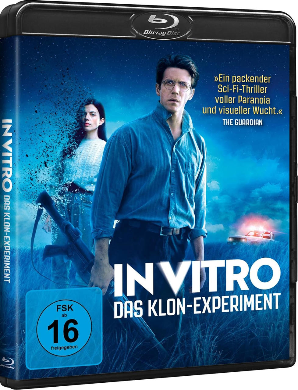 Filmcover: Mann und Frau in einem Feld, Titel 'IN VITRO', eine Waffe und der Text 'DAS KLON-EXPERIMENT'.