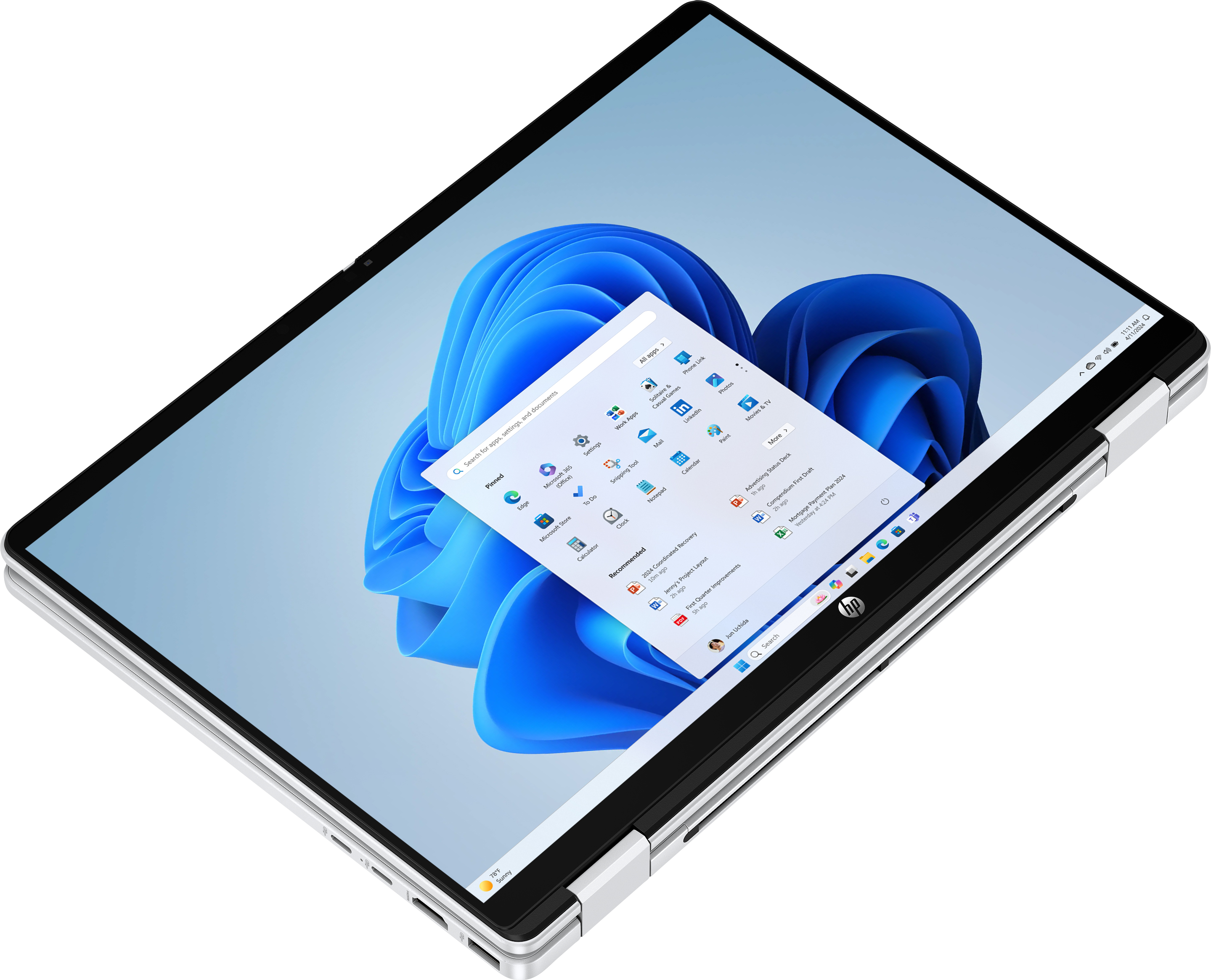 Geöffnetes HP-Laptop mit Windows 11. Der Bildschirm zeigt App-Symbole und einen blauen, abstrakten Hintergrund.