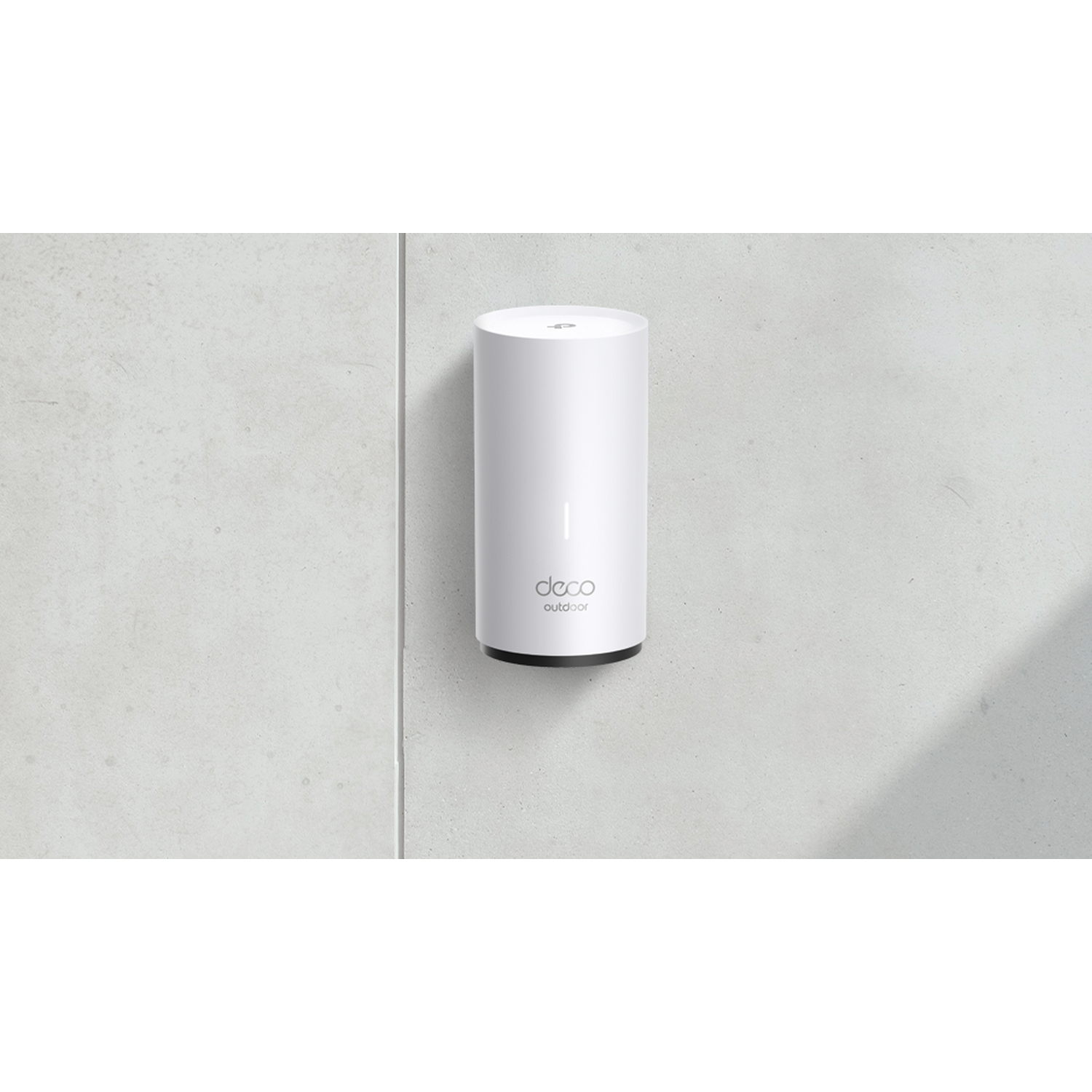 A white, cylindrical Deco Outdoor device is mounted on a light gray wall. The device has a black base and the Deco logo.