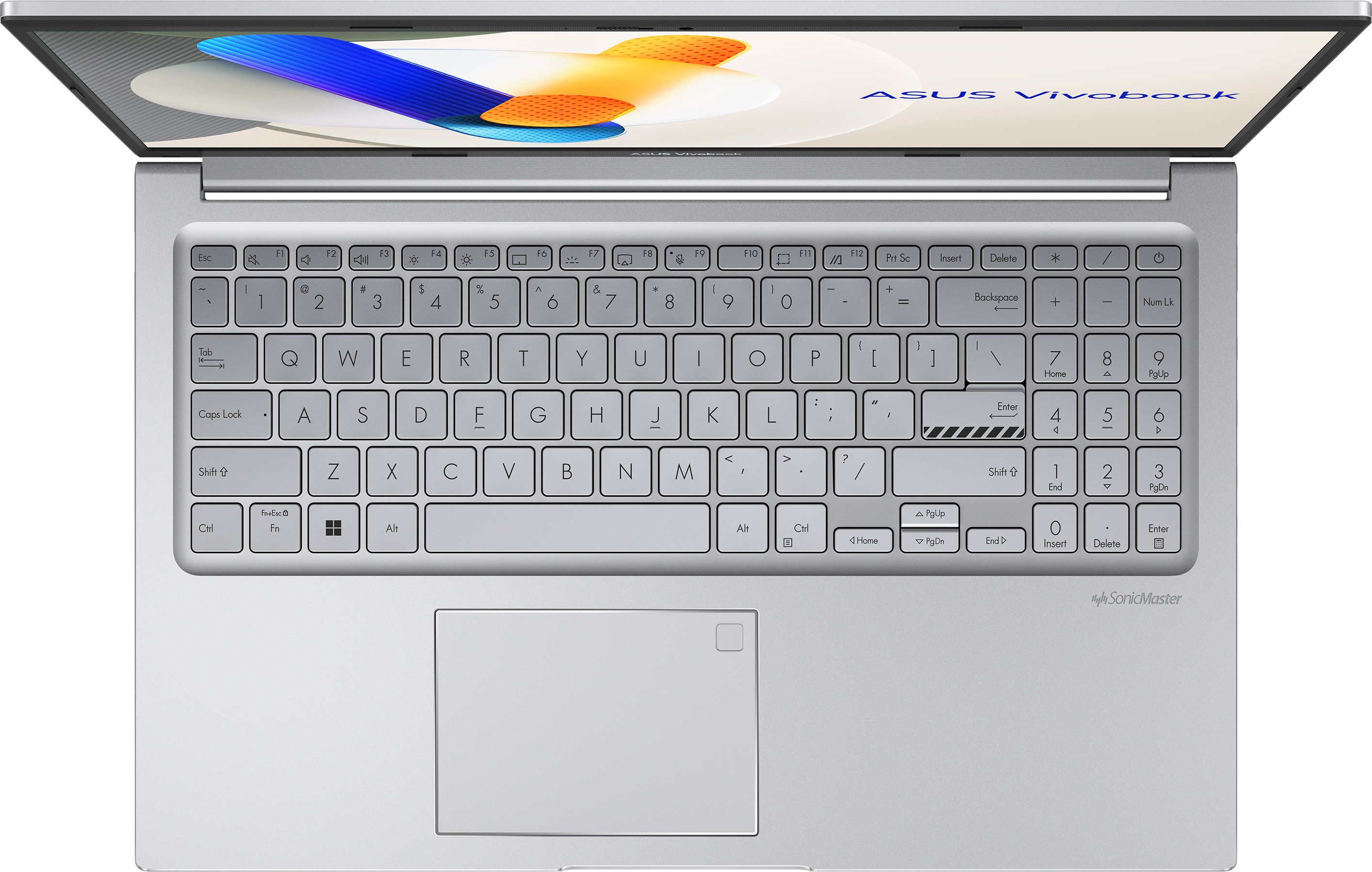 Felülnézet egy nyitott ASUS Vivobook laptopról. A billentyűzet fókuszban van. Ezüst szín. Fekete háttér.