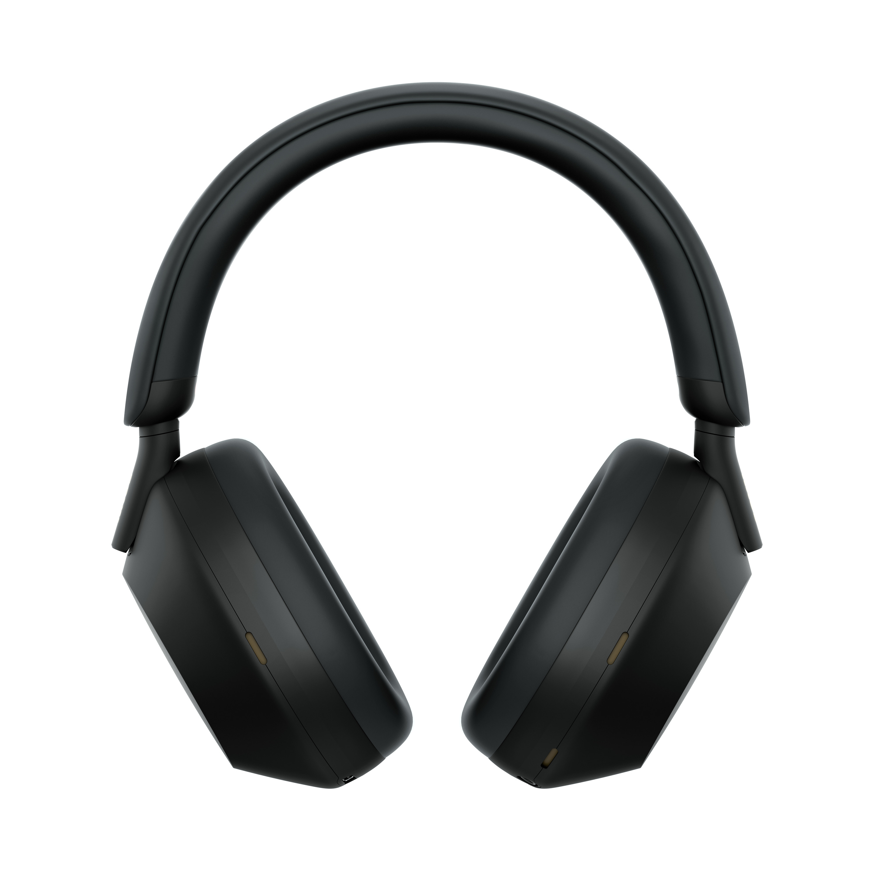 Un par de auriculares negros sobre un fondo blanco. Los auriculares están centrados y ligeramente angulados.
