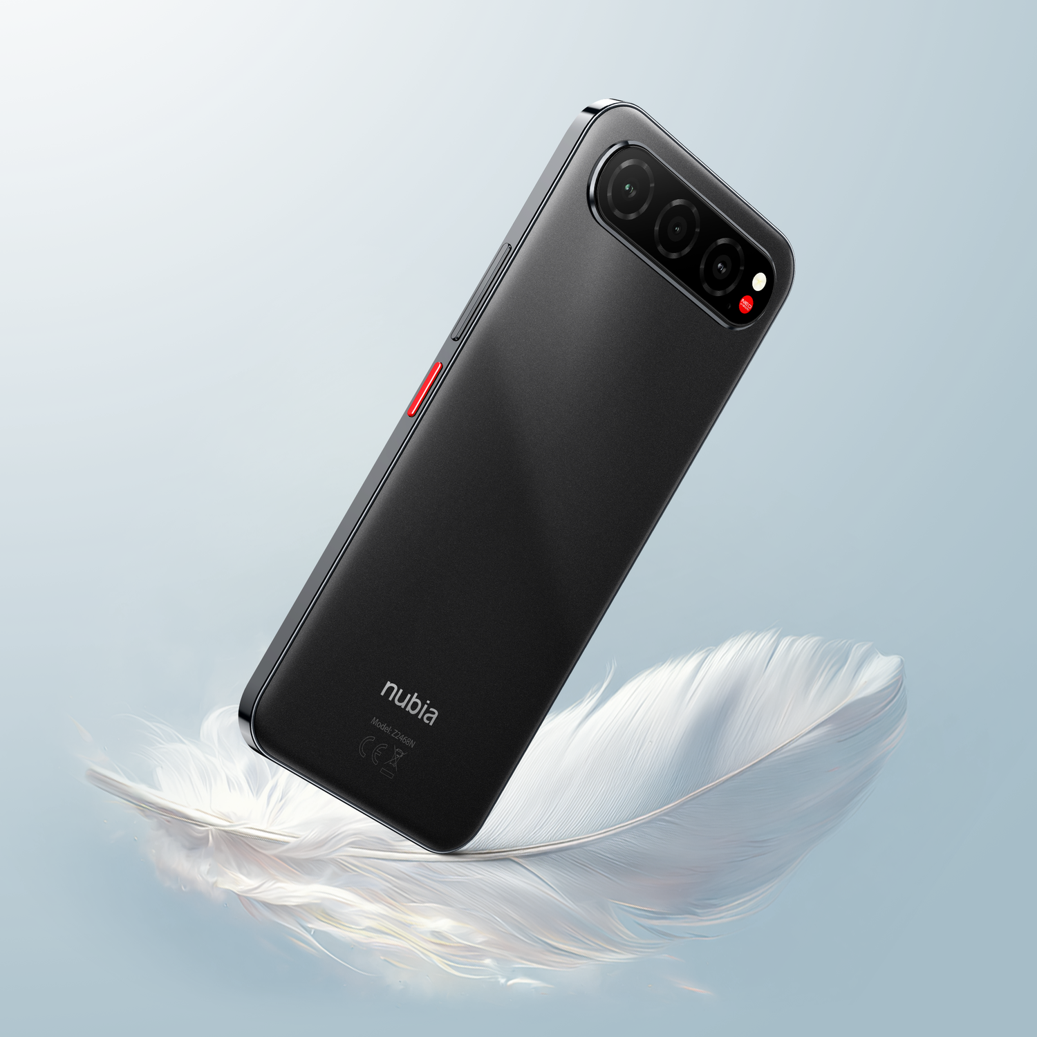 A black smartphone with triple cameras and a red button is set on a white feather against a gradient blue background.