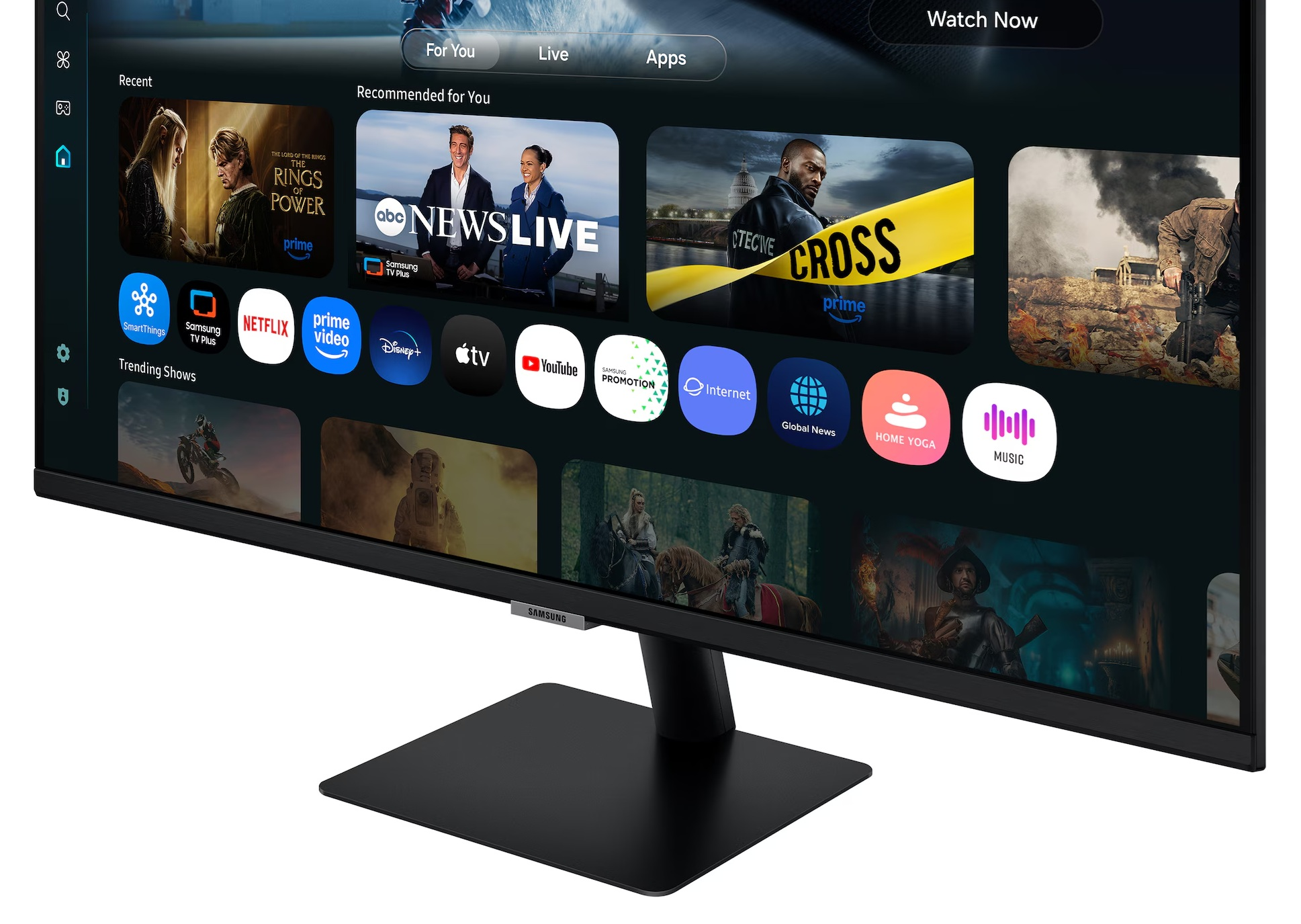 Czarny monitor Samsung wyświetla interfejs Smart TV z aplikacjami. Wyświetlane są programy, z czarną podstawą i logo Samsung.