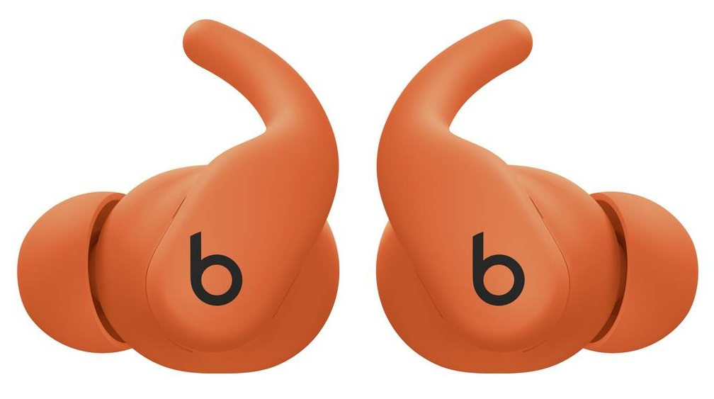 Dwa pomarańczowe słuchawki Beats, każda z logo 'b'. Słuchawki mają zakrzywioną konstrukcję.