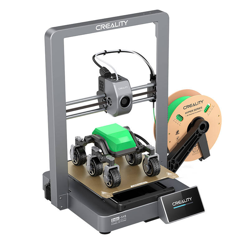 Egy 3D nyomtató zöld tárggyal a nyomtatóágyon. Egy zöld filament tekercs található a jobb oldalon. A nyomtató szürke.