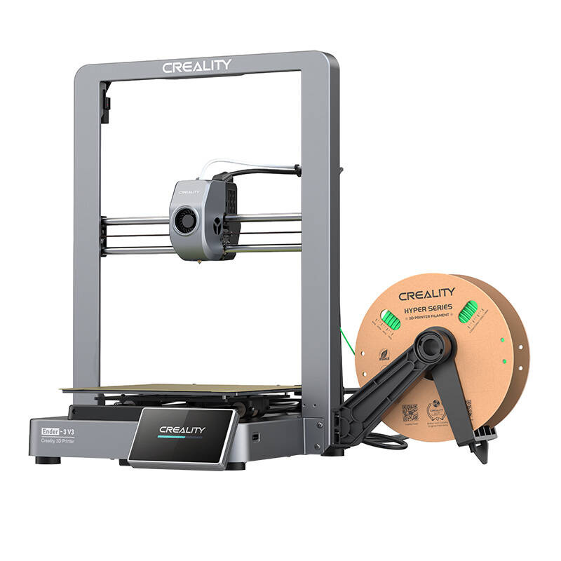 Egy CREALITY márkájú 3D nyomtató. A nyomtató szürke, nyomtatási ággyal és egy zöld filament tekercsel az oldalán.