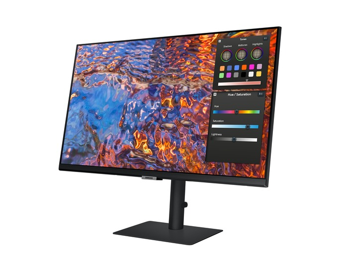 Egy Samsung monitor színes, absztrakt képet jelenít meg. Színbeállító eszközök a képernyőn. A monitor fekete állványon van.