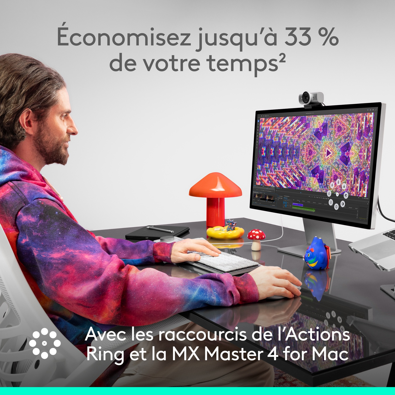 Homme utilisant un ordinateur. Pull coloré, moniteur avec design, accessoires sur le bureau. Texte : Économisez jusqu'à 33% de votre temps.