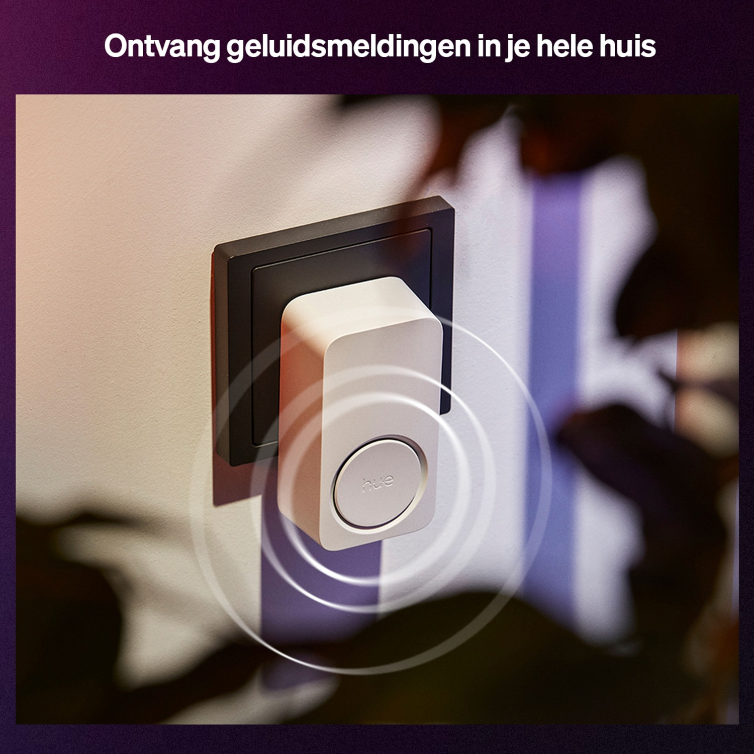 A white smart home device with a button is plugged into a wall outlet. Sound waves emanate from the device. Dark background.