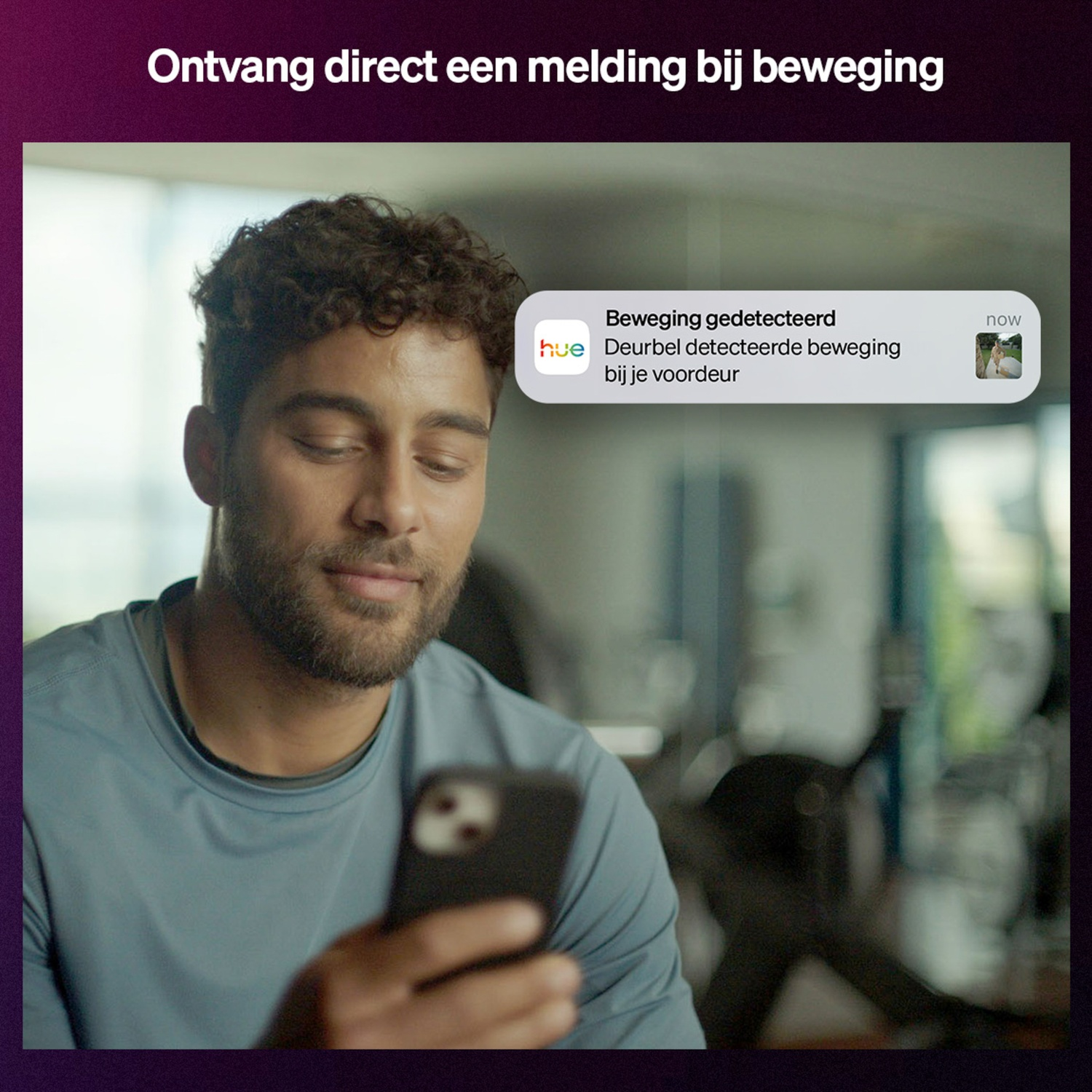 Man looking at phone, notification on screen: 'Movement detected'. The notification says: Doorbell detected movement at your door.