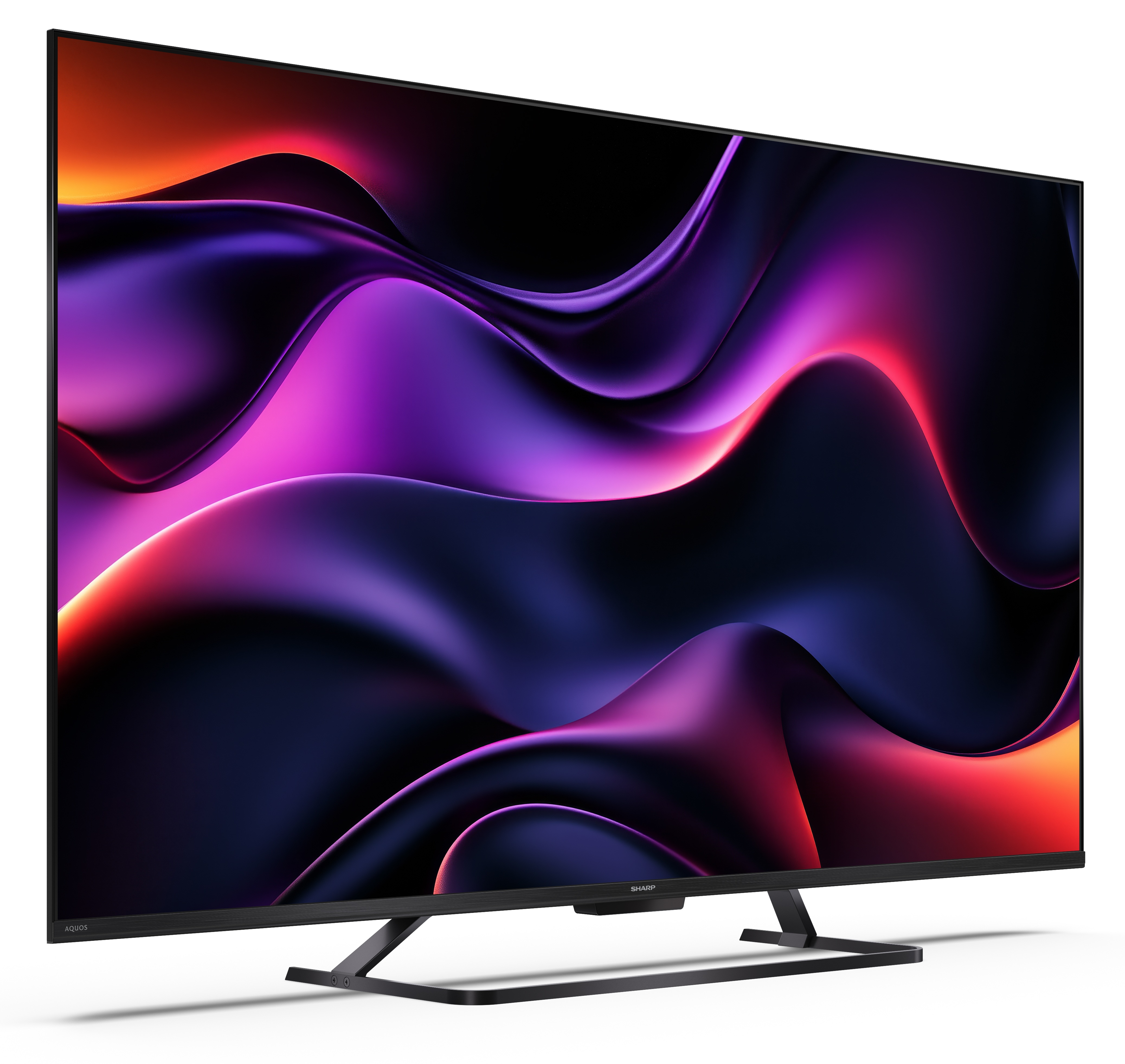Telewizor Sharp wyświetla wirujący abstrakcyjny wzór w kolorach fioletowym, czerwonym i czarnym. Jest na czarnym stojaku na białym tle.
