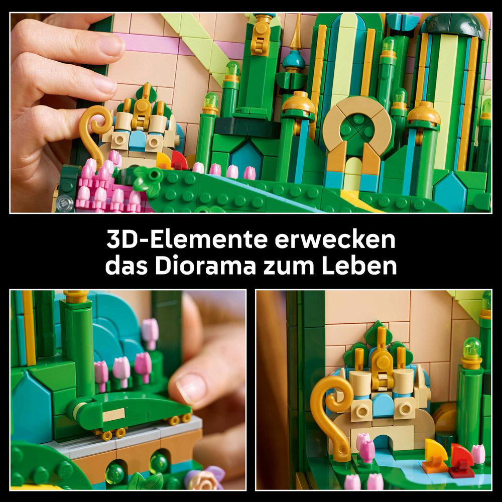 Eine Hand hält ein grünes und goldenes Lego-Bauset. Pinke Blumen und grüne Säulen schmücken das Set, mit einer goldfarbenen ringförmigen Struktur.