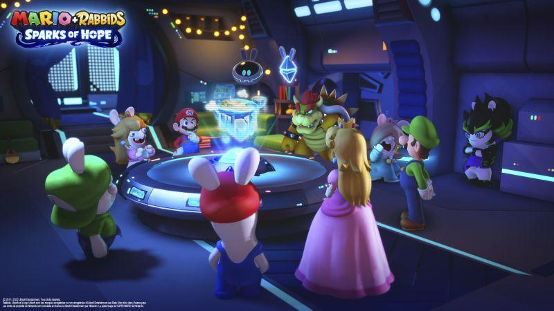 Mario- und Rabbids-Charaktere in einem Raumschiff-Interieur. Mario, Peach, Luigi und andere versammeln sich um einen Tisch.