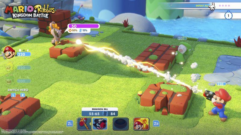 Mario in blauem Anzug schießt mit einer Waffe auf einen Gegner in grünem Anzug. Das Spiel spielt in einer grünen Umgebung.