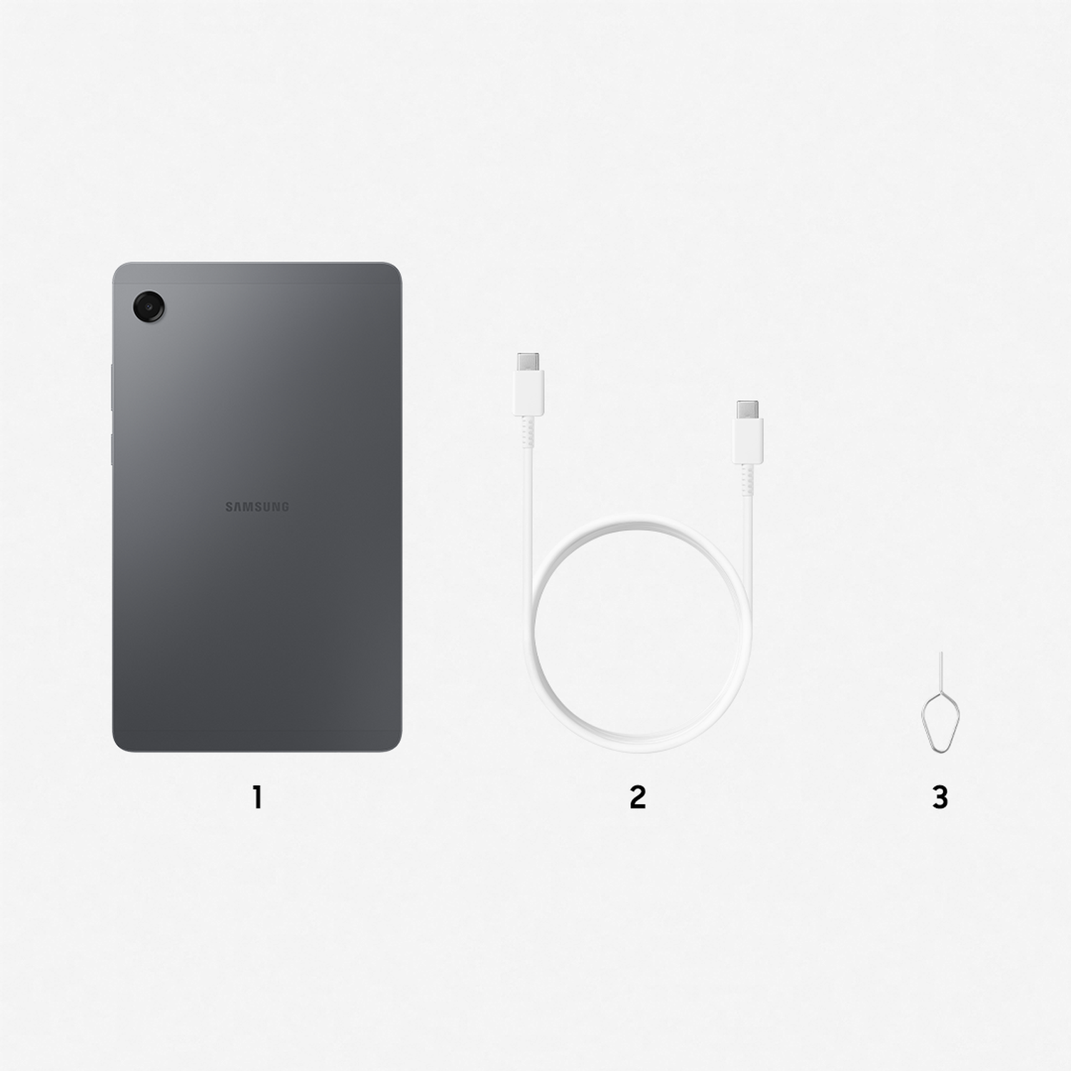 A gray Samsung tablet, a white USB-C cable, and a SIM card ejector tool are arranged on a white surface.