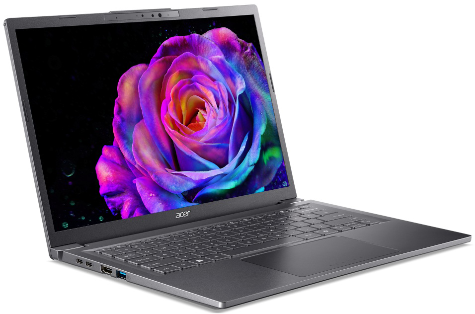 Egy szürke laptop színes rózsa képet jelenít meg. A laptop szögben van, látható a billentyűzet, a tapipad és a portok. Fehér háttér.