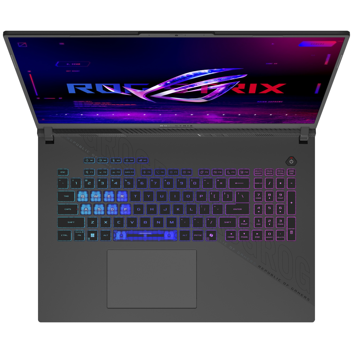 Un ordinateur portable avec un écran ouvert affichant le logo ROG. Le clavier est éclairé d'une lumière colorée. Le fond est sombre.