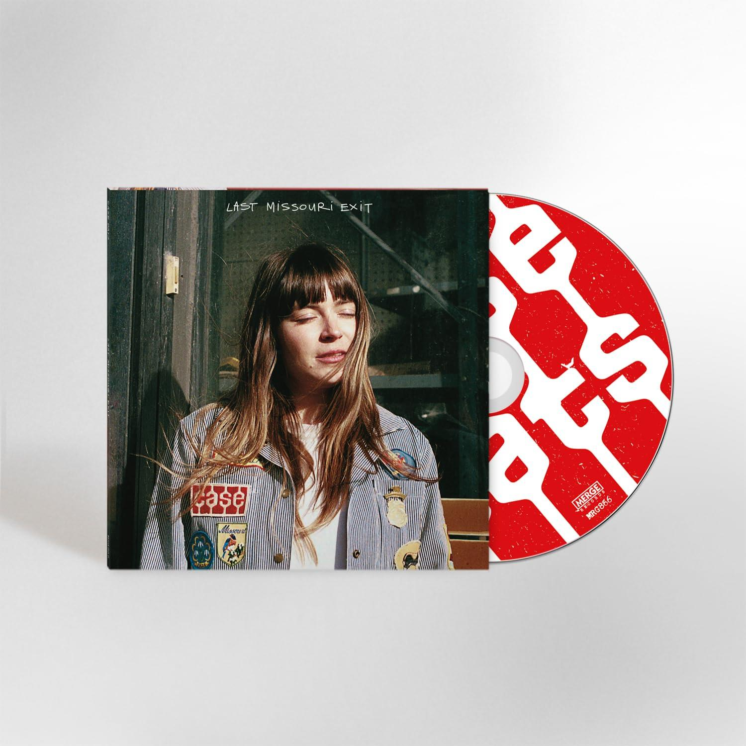 Albumcover mit einer Frau in gestreifter Jacke, CD teilweise sichtbar. Rote CD mit weißem Text. Albumtitel "Last Missouri Exit".