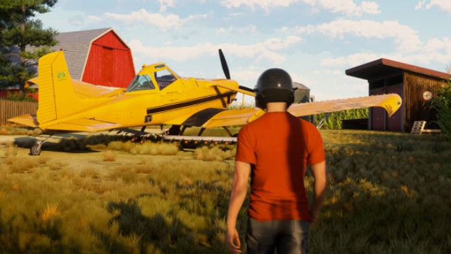 Ein gelbes Flugzeug zur Feldbearbeitung auf einem Grasfeld. Ein Mann in einem orangefarbenen Hemd und Helm steht davor.