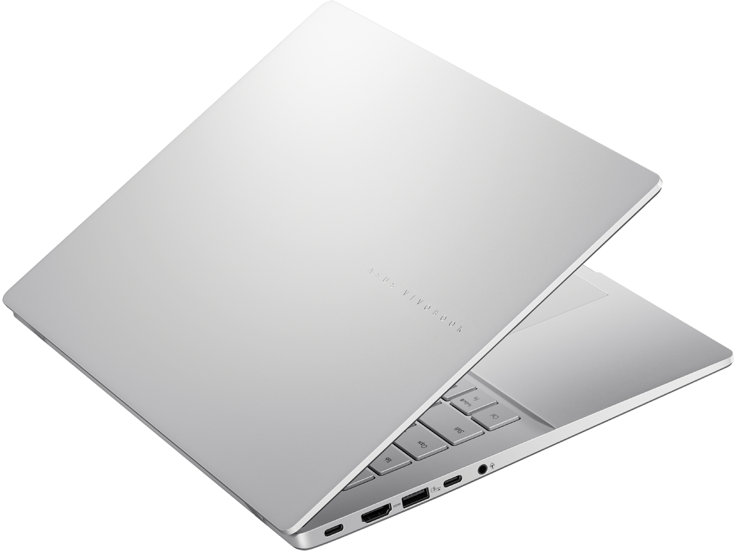 Una laptop plateada está ligeramente abierta, revelando el teclado y los puertos. El logotipo de ASUS Vivobook está en la tapa.