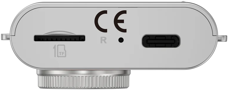 Silberner Kameraboden mit SD-Kartensteckplatz, USB-C-Anschluss und CE-Zeichen. Das Objektiv ist unten sichtbar.