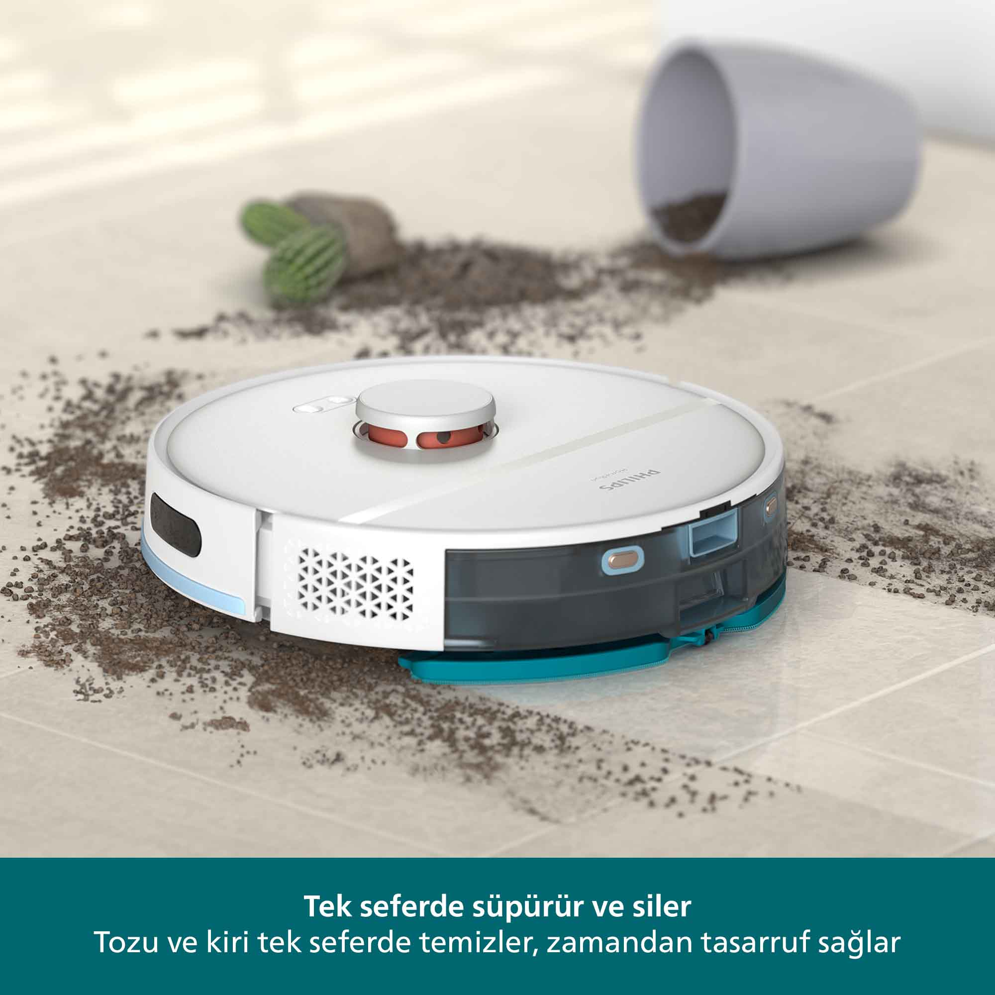 Beyaz bir robot süpürge, kirli bir zemini temizliyor. Enkaz etrafa saçılmış. Arka planda bir bardak ve küçük bir bitki var.