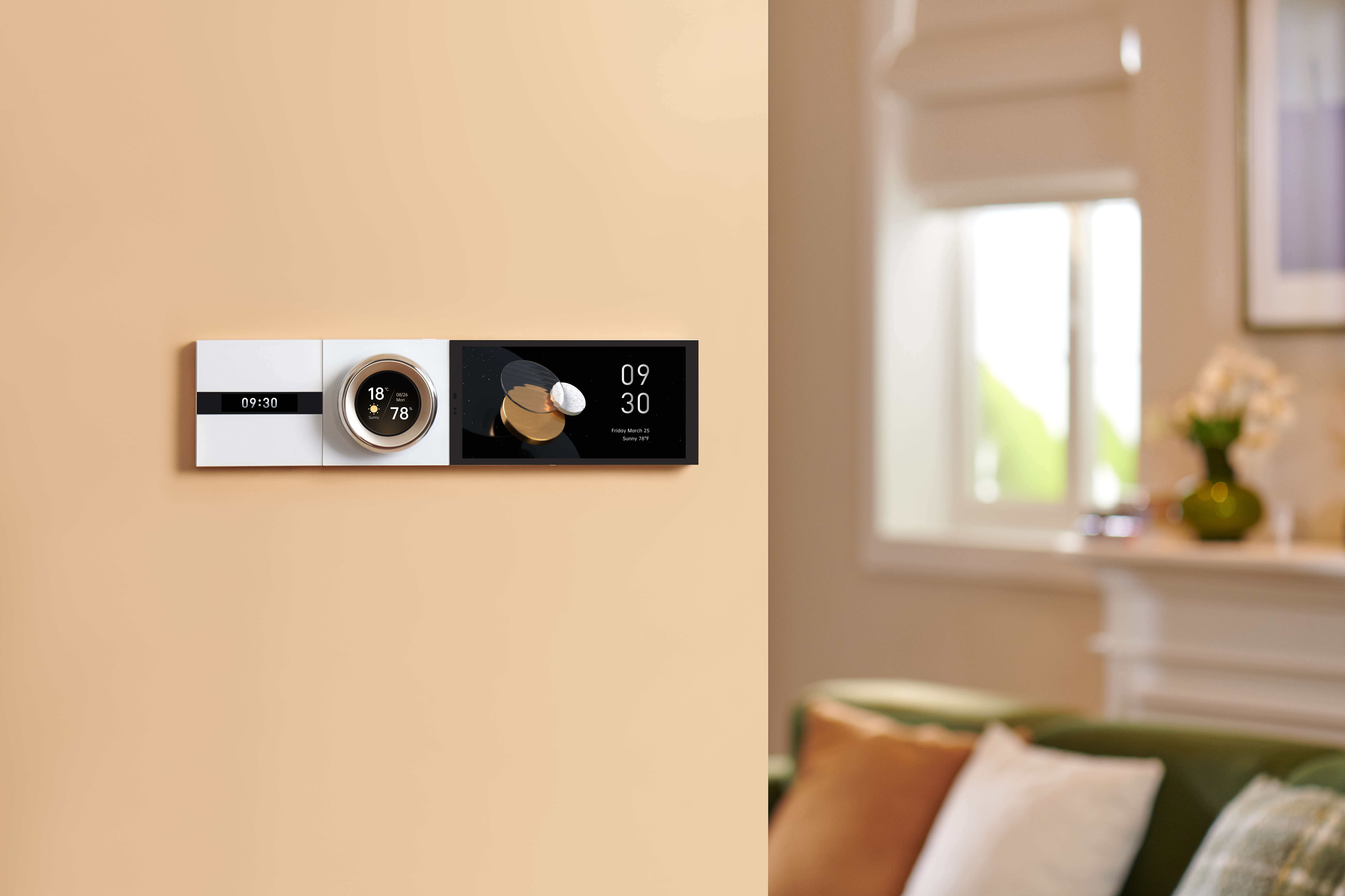 Ein intelligenter Thermostat zeigt Zeit, Temperatur und Luftfeuchtigkeit an einer beigen Wand an. Ein Wohnzimmer mit Fenster und Sofa ist im Hintergrund unscharf.