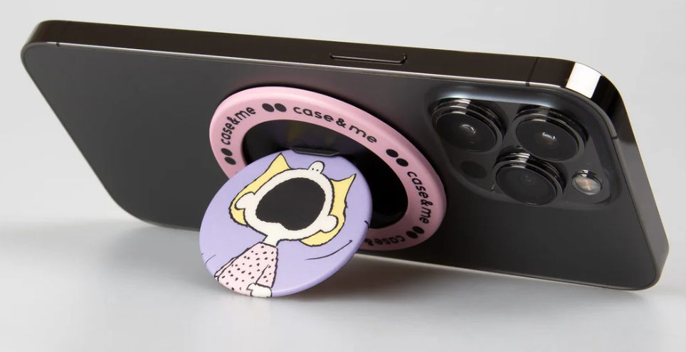 Schwarzes Telefon mit einem Pop-Socket. Der Sockel ist rosa mit den Worten case&me und hat eine Cartoon-Figur darauf.