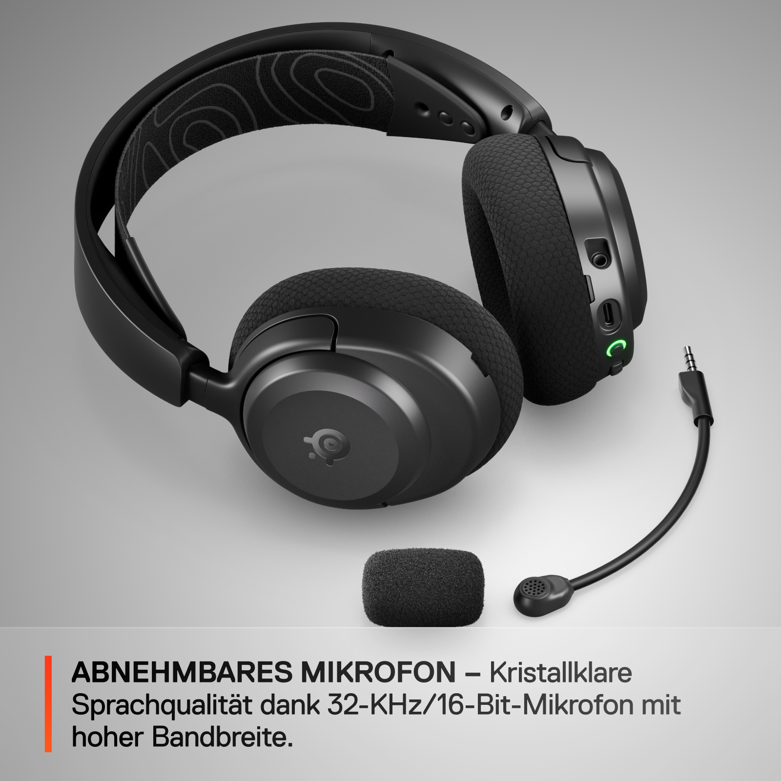 Schwarzes Headset mit abnehmbarem Mikrofon und separater Schaumstoff-Mikrofonabdeckung auf weißer Oberfläche.