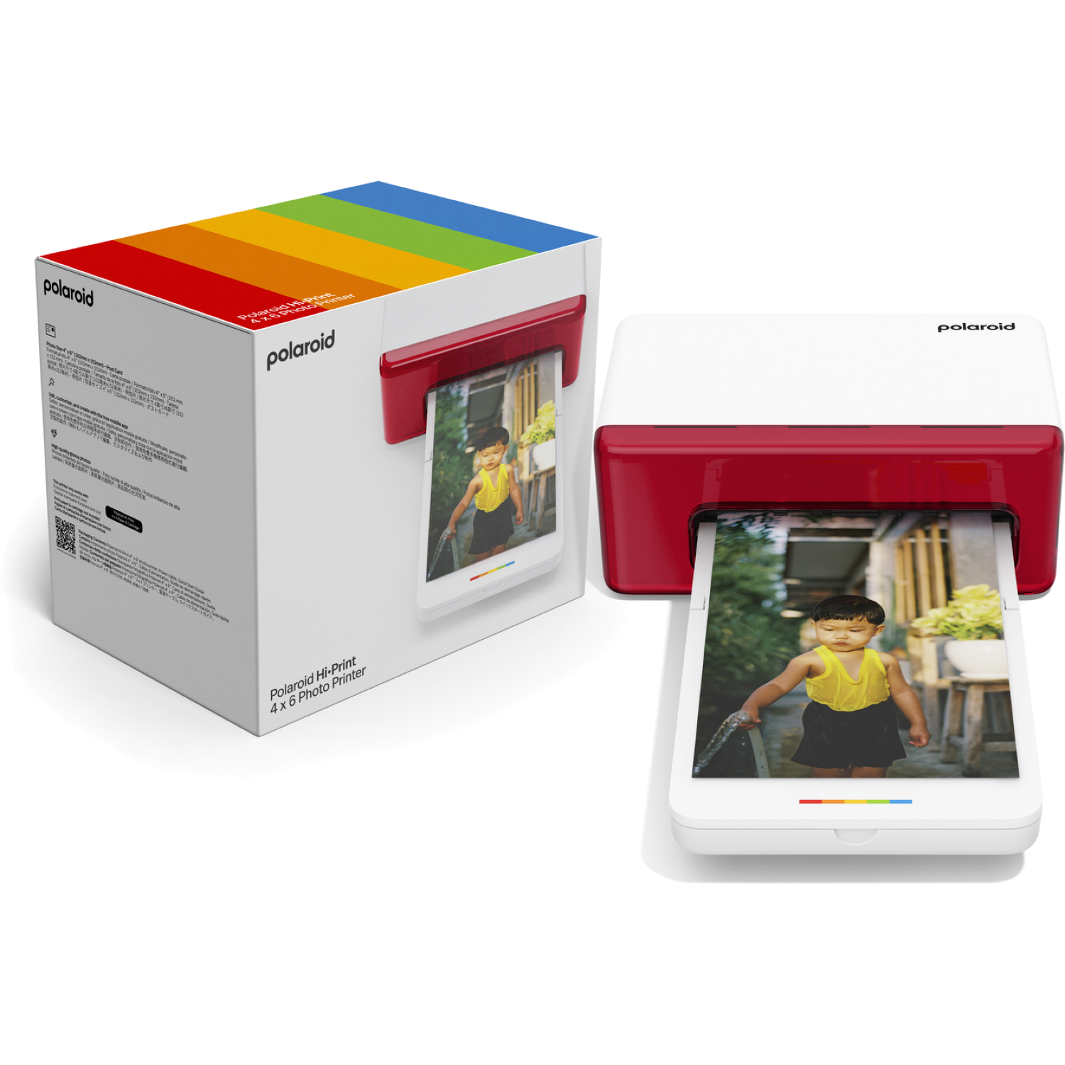 A Polaroid Hi-Print printer and box are shown. The printer is white and red, printing a photo of a child. The box has a rainbow design.