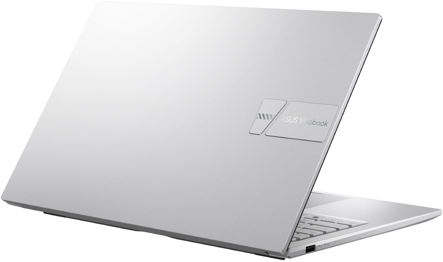 Un portátil plateado con la tapa abierta. El logotipo de ASUS Vivobook es visible en la tapa. El teclado también es visible.