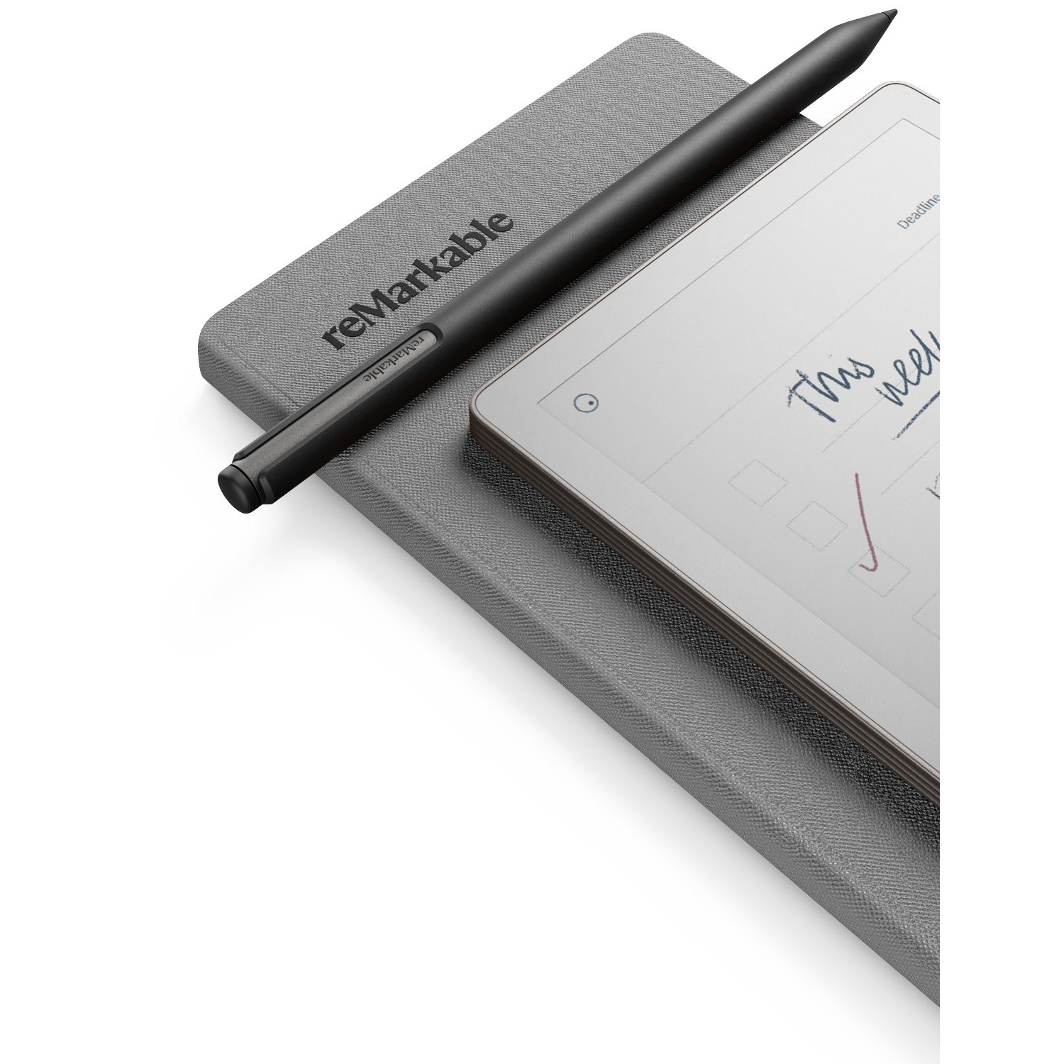 A black stylus pen rests on a gray tablet and a gray notebook. The tablet displays handwritten text with a checkmark.