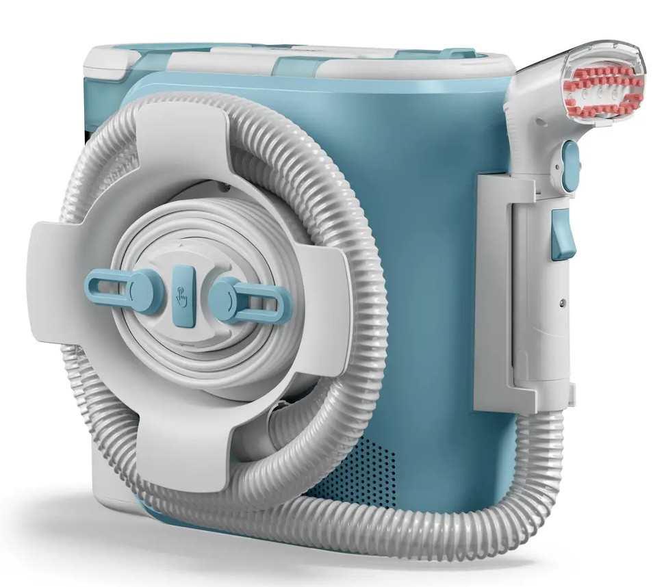 Jasnoniebieskie i białe urządzenie medyczne. Posiada wąż i głowicę czyszczącą. Głowica zawiera różowe włosie.