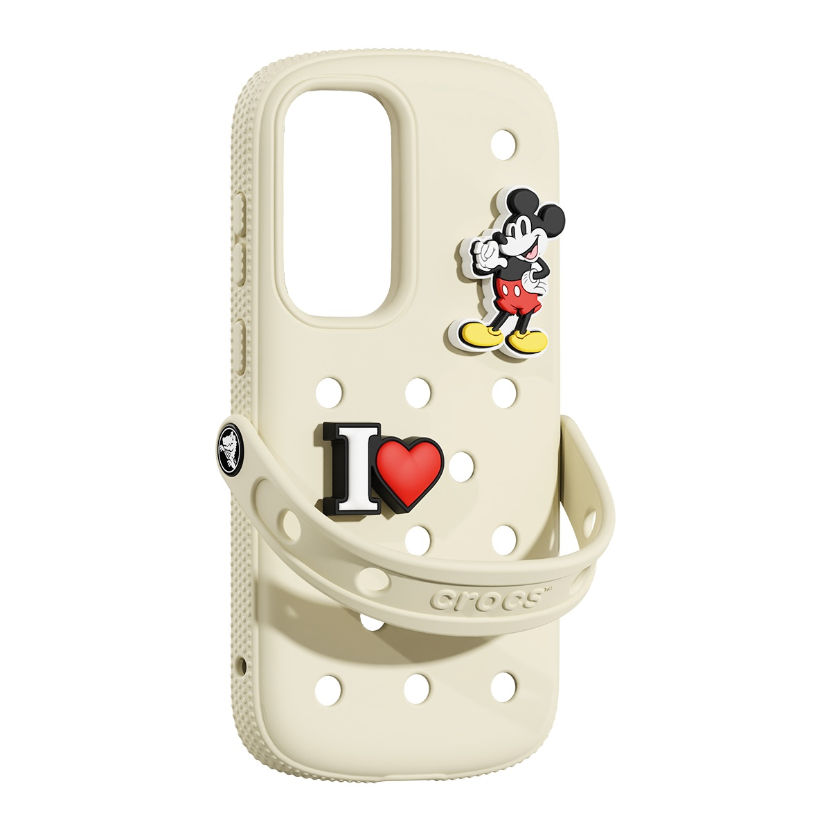 Mickey Mouse ve 'I heart' takıları olan bej Crocs telefon kılıfı. Kılıfın delikleri, düğmeleri ve bir kayışı var.
