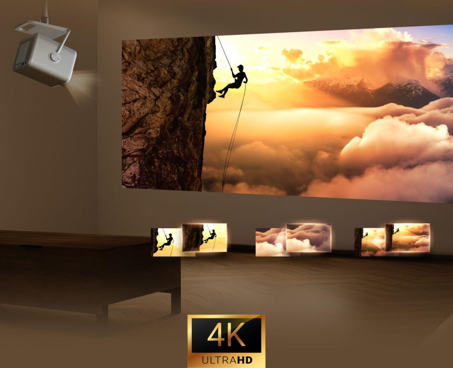 Projektor wyświetla wspinacza na skale na tle zachmurzonego nieba. Dodatkowe obrazy pokazują różne sceny. Obecne jest logo 4K Ultra HD.
