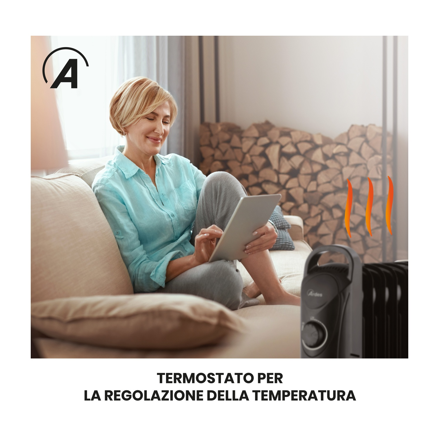 Una donna usa un tablet su un divano. Un termosifone è di fronte a lei, una catasta di legna sullo sfondo.