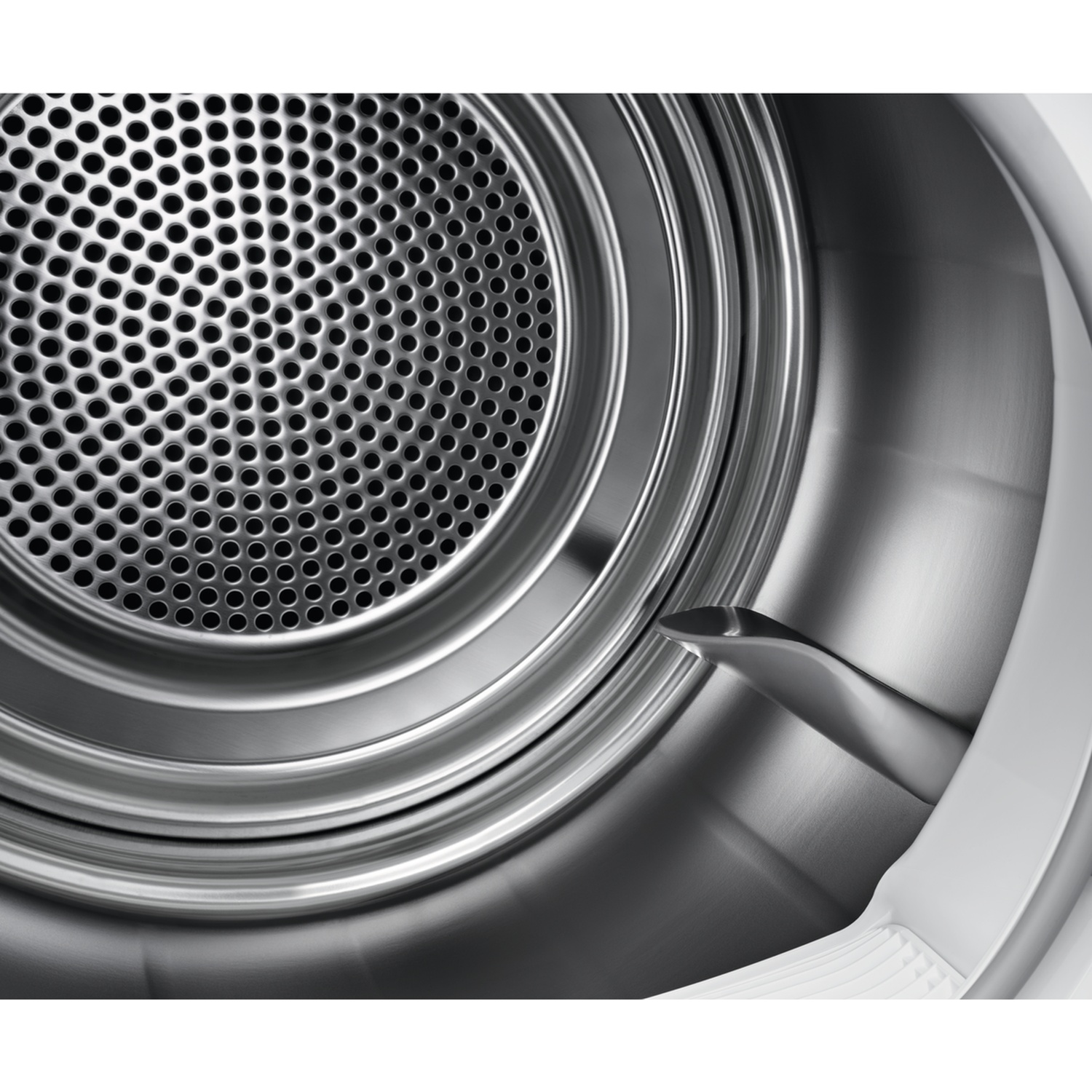 Close-up van een wastrommel. Een geperforeerd metalen scherm is zichtbaar in de roestvrijstalen trommel, samen met een wit plastic element.