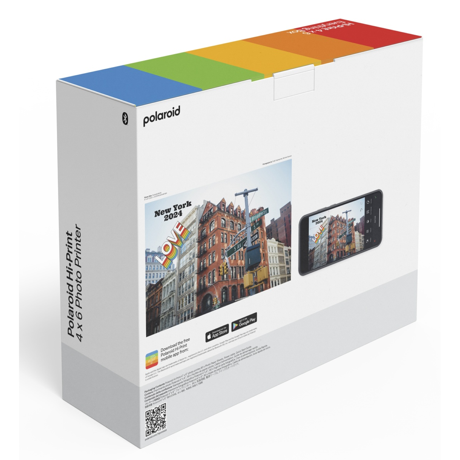 Polaroid printerbox met een New York-afbeelding en een telefoon met dezelfde afbeelding. Doos heeft regenboogkleuren.