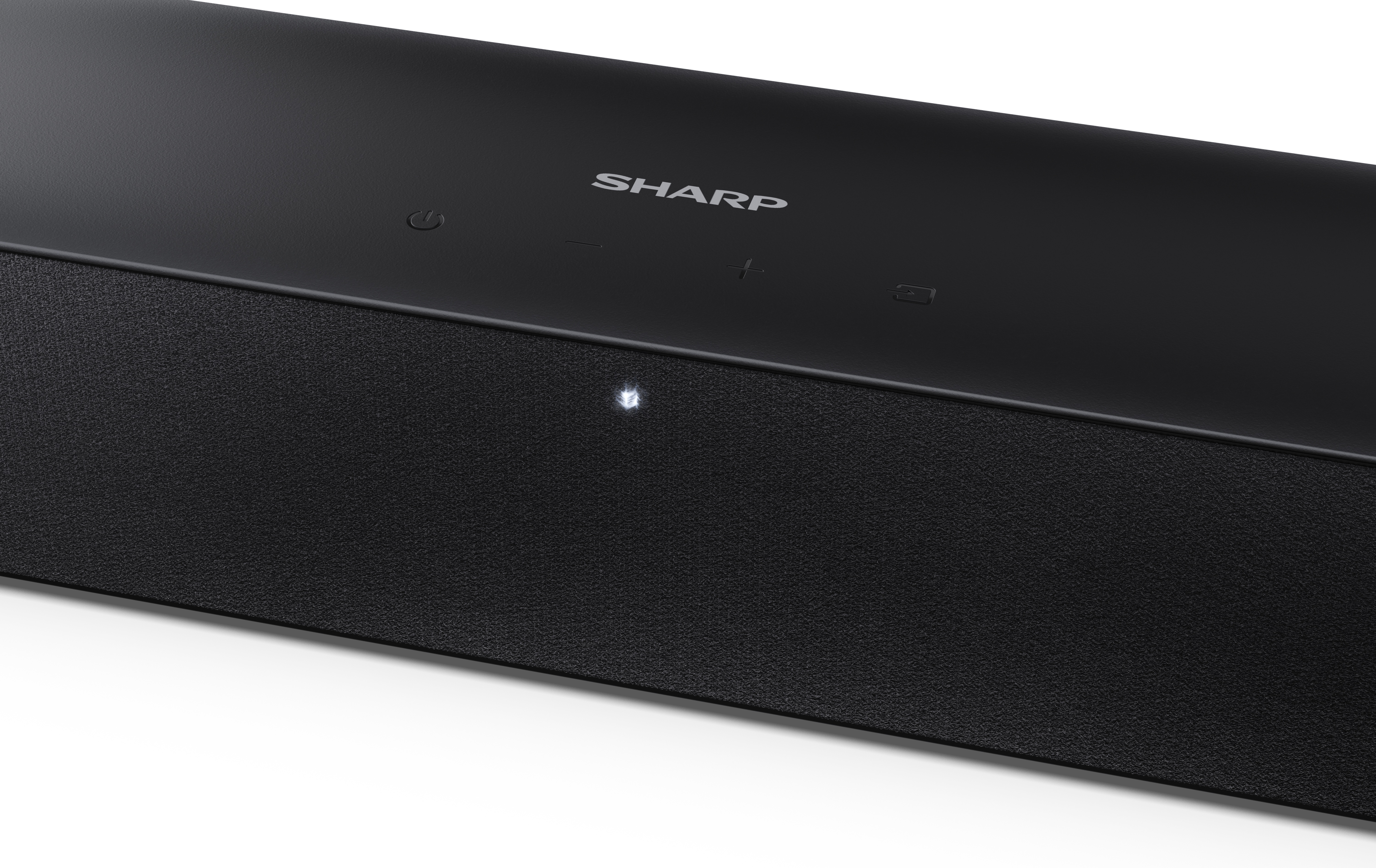 Czarny soundbar z logo SHARP. Ma przyciski sterowania na górze i teksturowany przód. Małe światło świeci.